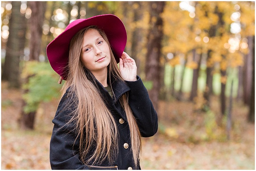 Perry High School Senior girl, wearing fun maroon hat, photographed at OARDC during fall.Photographed by Jamie Lynette Photography, Wayne County Senior Portrait Photographer. 