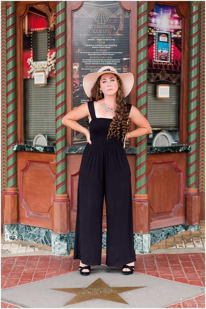 Perry High School Senior girl standing in front of box office at Palace Theater downtown Canton, Ohio.  Photographed by Jamie Lynette Photography, Wayne County Senior Portrait Photographer. 