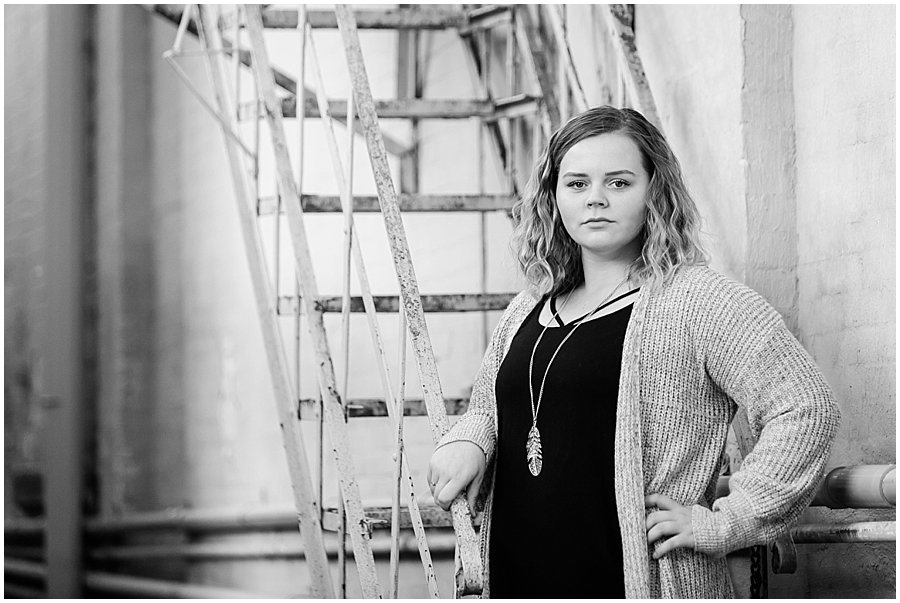 Downtown Wooster senior photo of girl standing by rustic metal steps by Jamie Lynette Photography