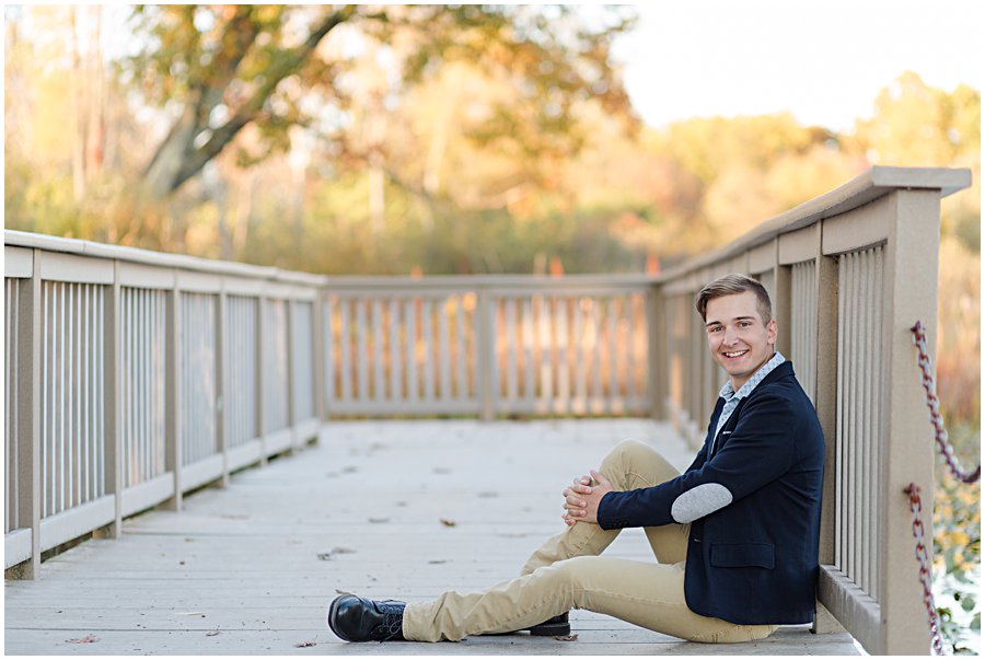 sippo lake fall senior session, perry high school student sitting on dock by Sippo Library.