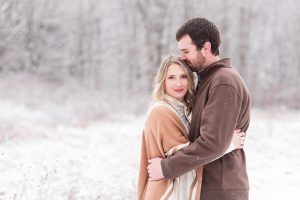 quail hollow snowy engagement session, hartville ohio, beautiful trees in background of couple.