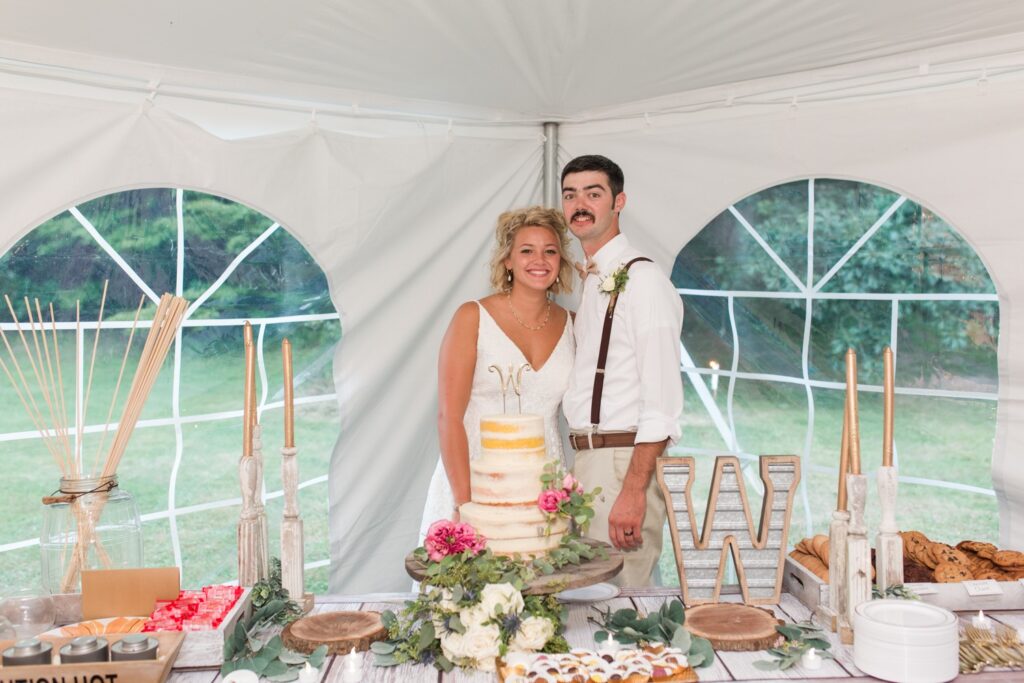 Bride and groom cutting their wedding cake during backyard reception