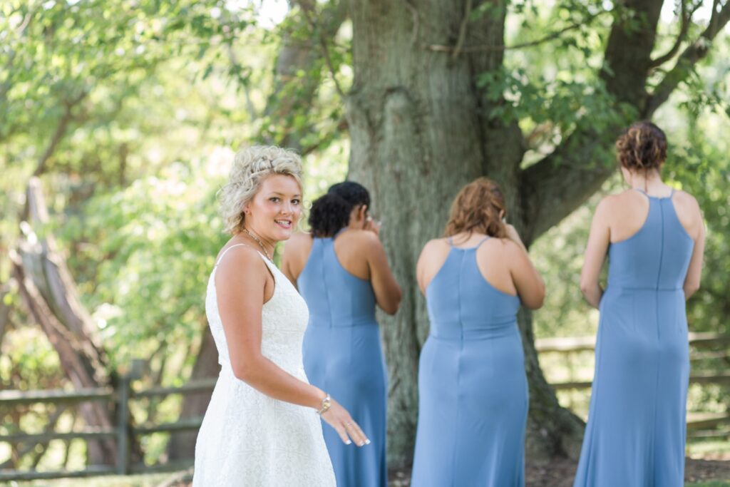 Bridesmaids wearing matching blue dresses for Wooster Ohio backyard wedding