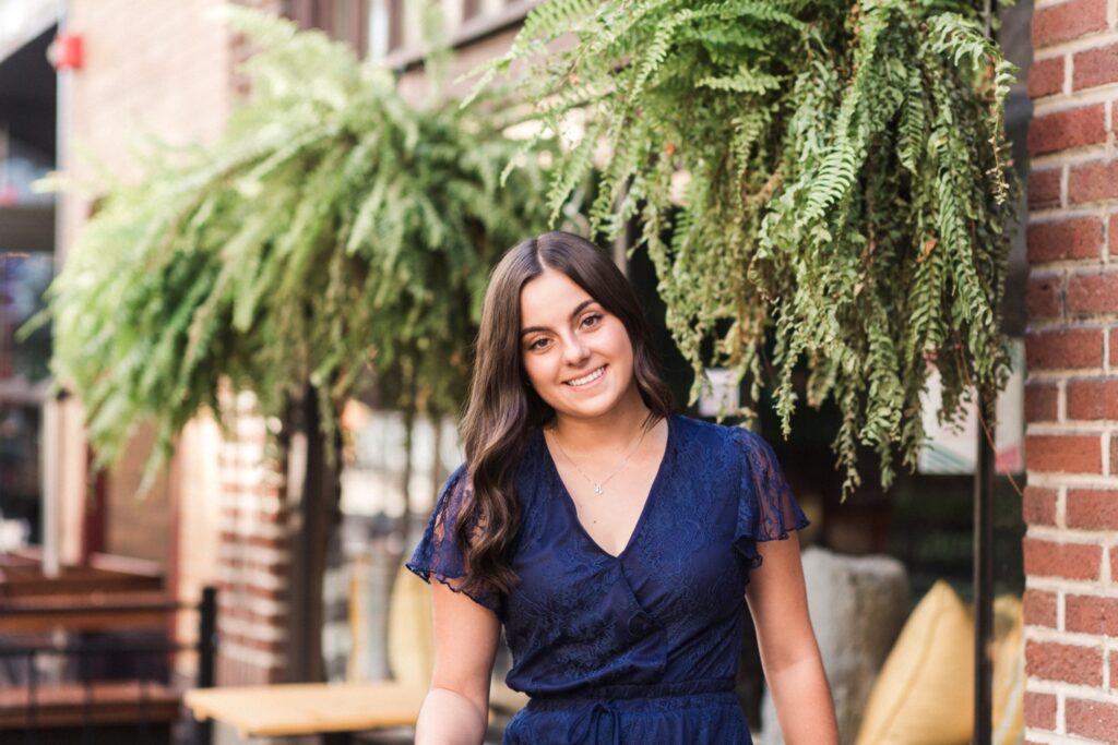 Makayla smiling on East 4th Street during her Downtown Cleveland Senior Photos
