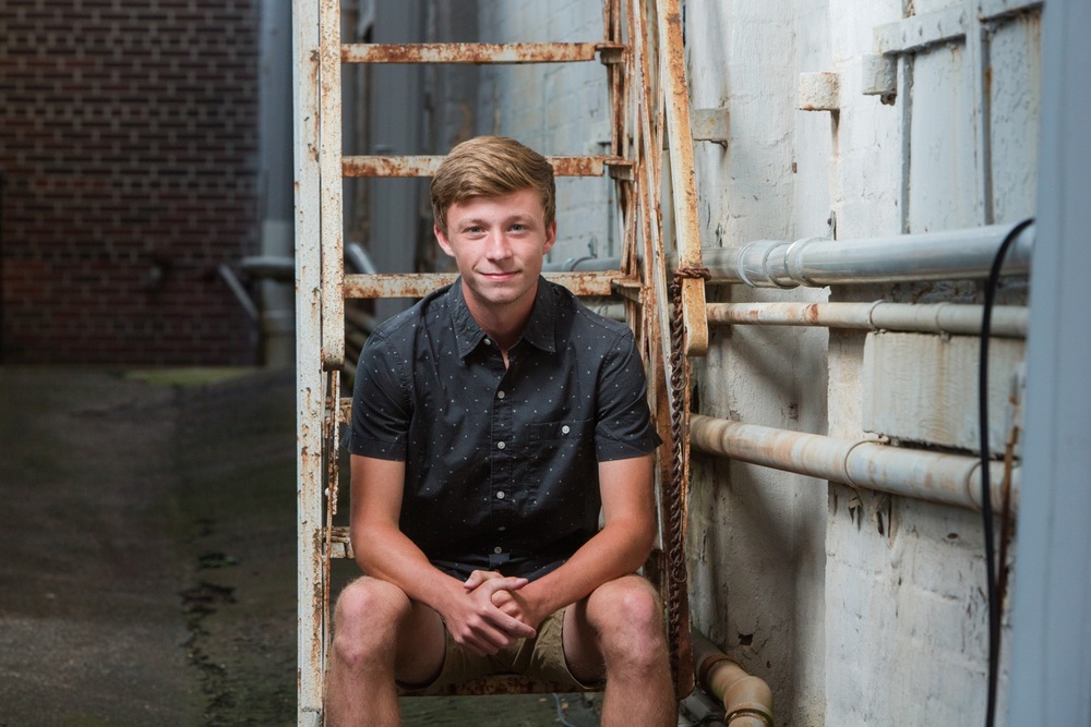 Calum, Triway High School senior, posing in a Wooster alleyway