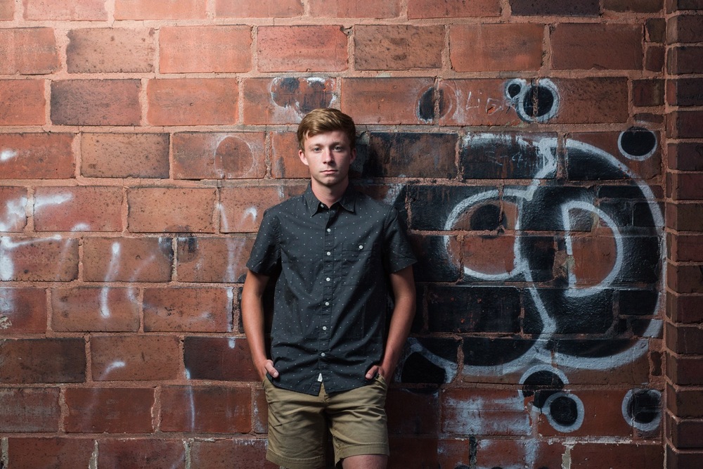Urban senior photo in Wooster with dramatic lighting
