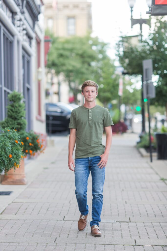 Calum, Triway High School senior, walking in a Wooster alleyway