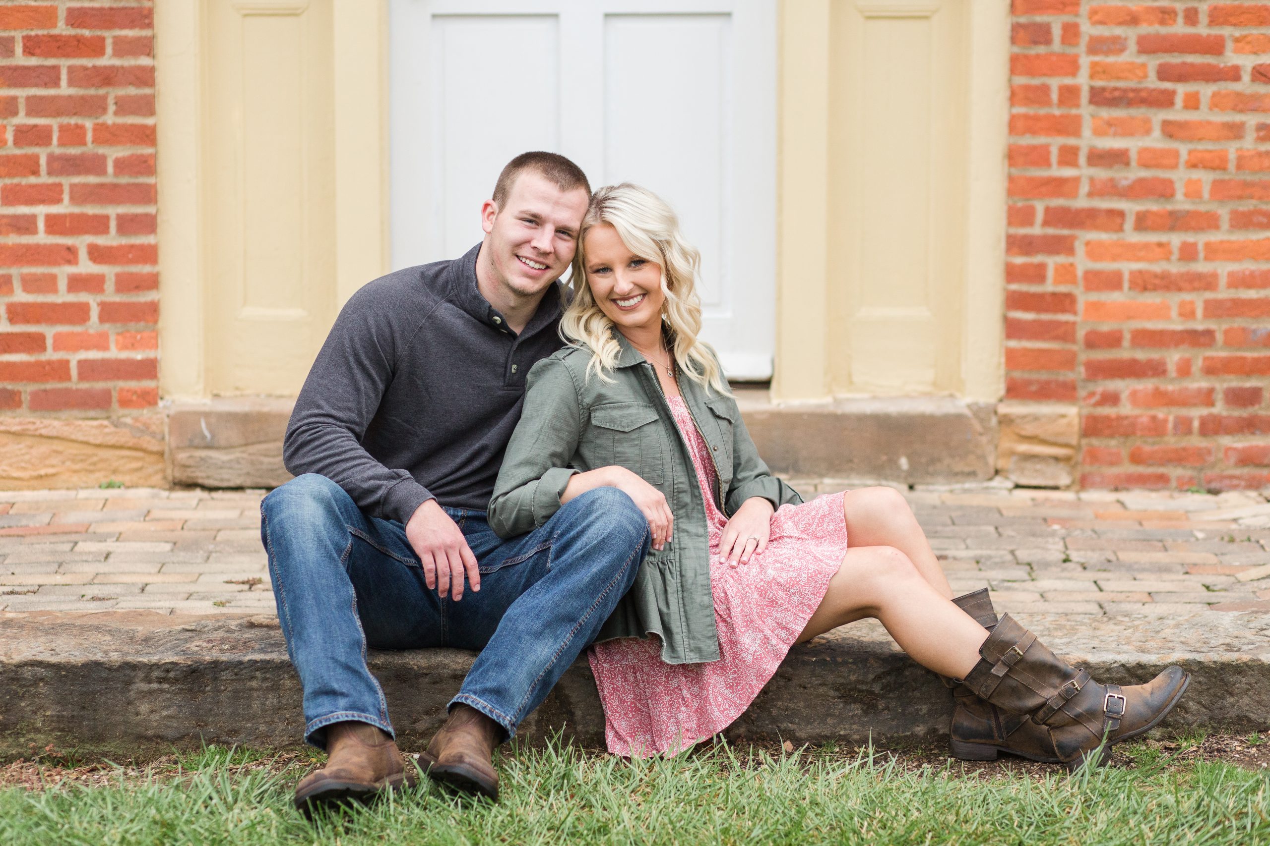 couple sitting on steps at Historic Zoar Village for their engagement photos