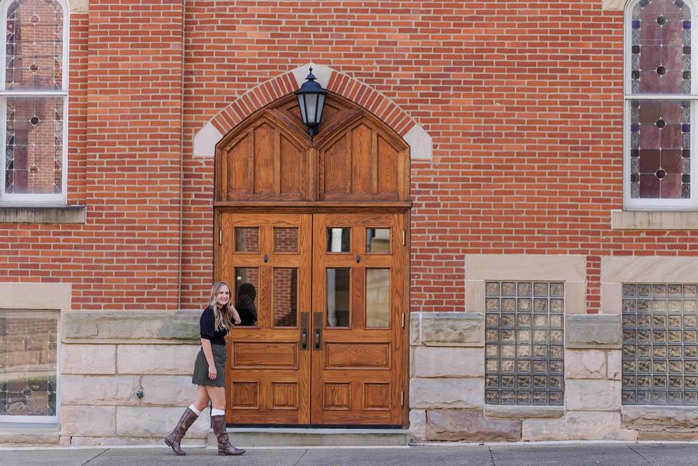 Senior girl photo session in downtown Wooster with brick buildings and city charm