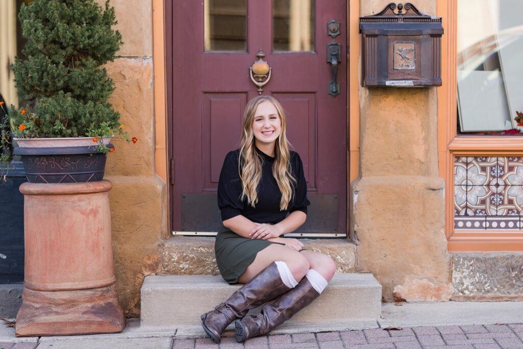 Emma poses confidently during her senior girl photo session in an urban setting