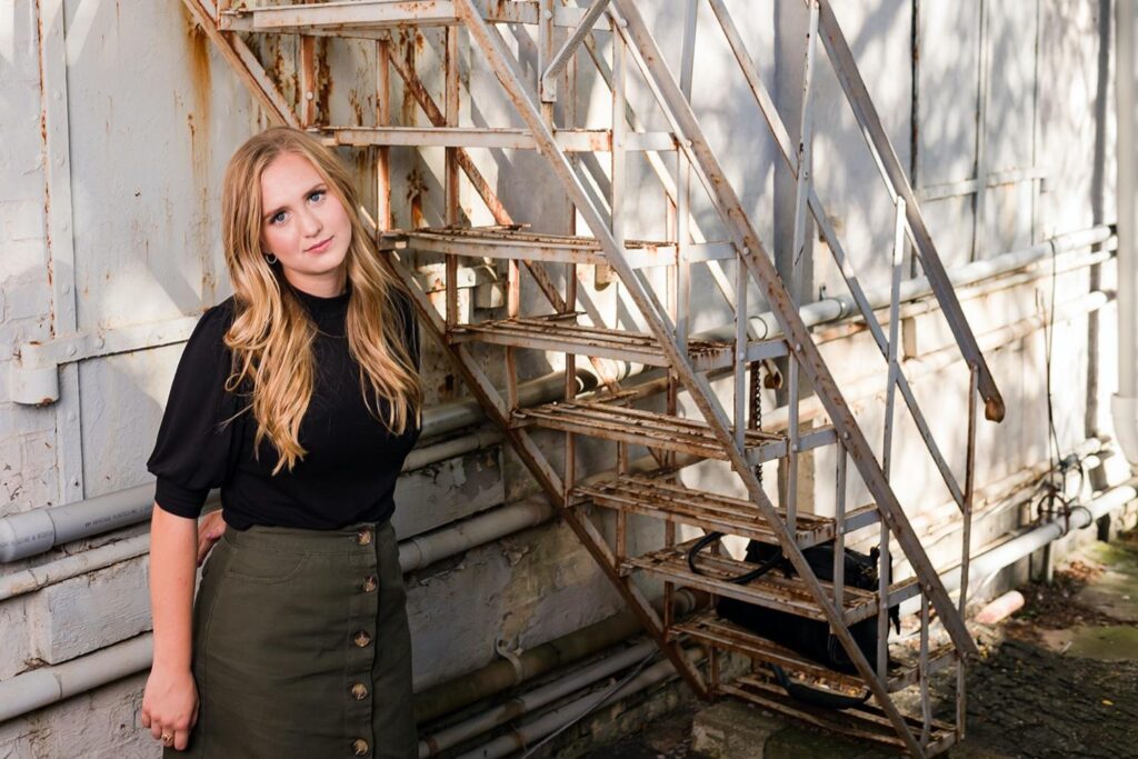 Urban senior girl photo session with fall light and historic storefronts in Wooster