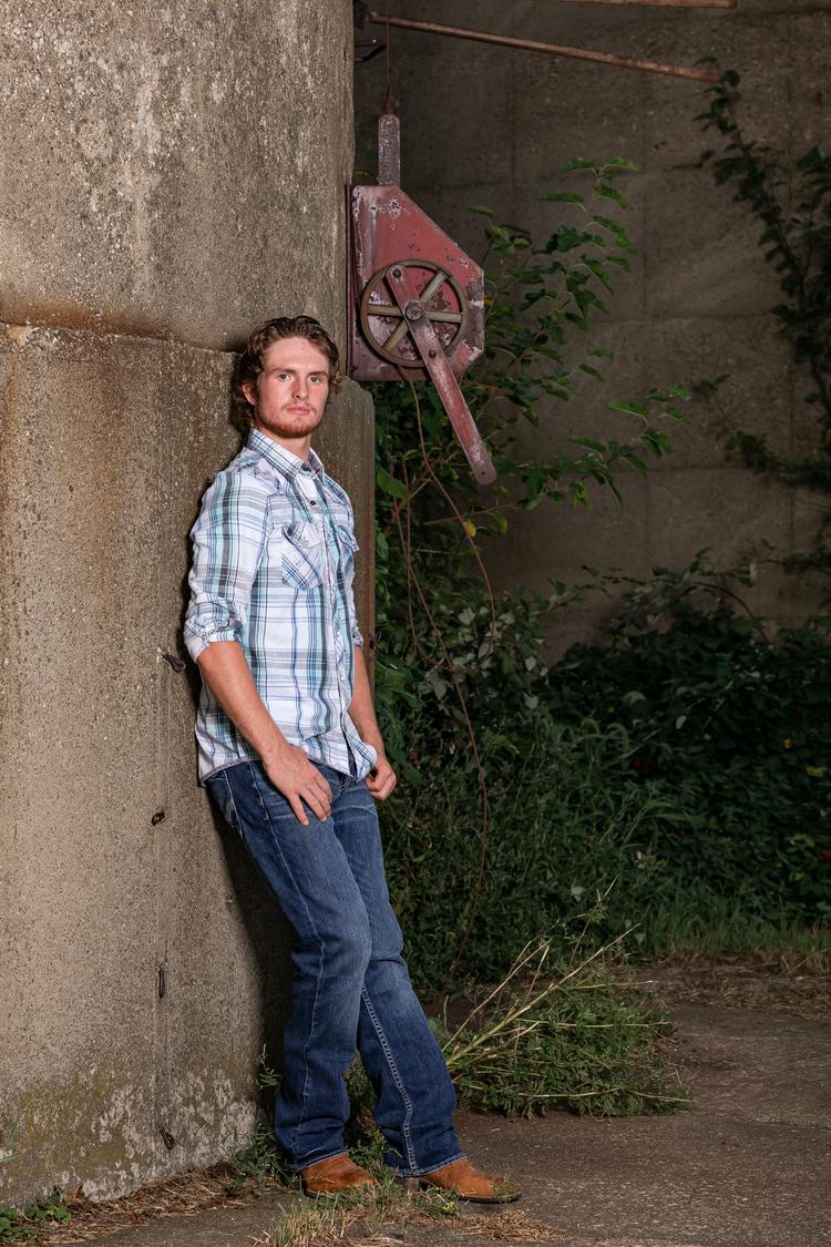 Senior photo with truck and sports gear at the farm