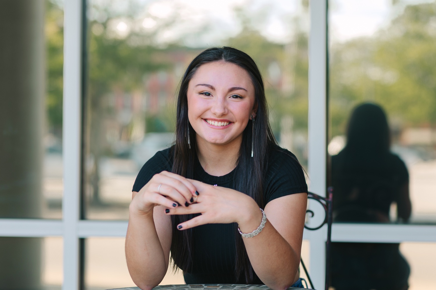 Chic senior portrait with upscale window reflection in Orrville