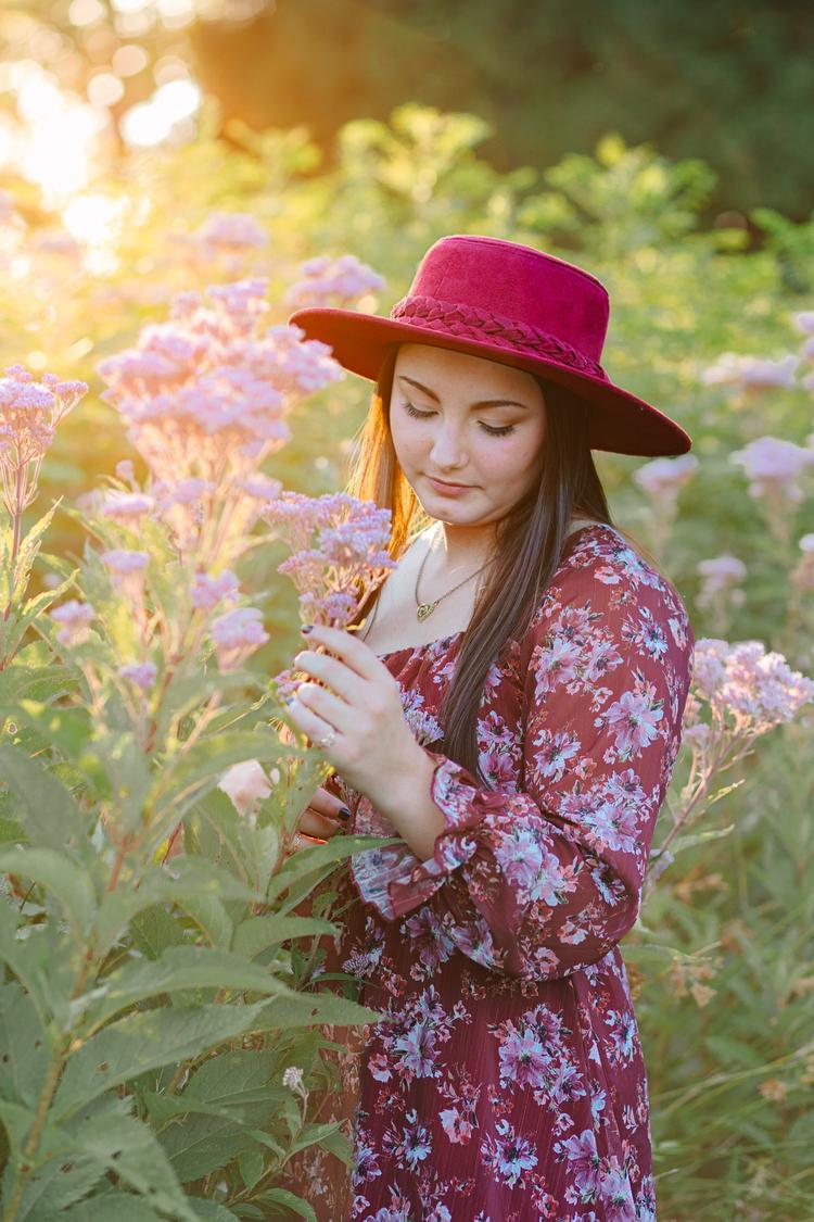 Abbie surrounded by flowers during her senior session