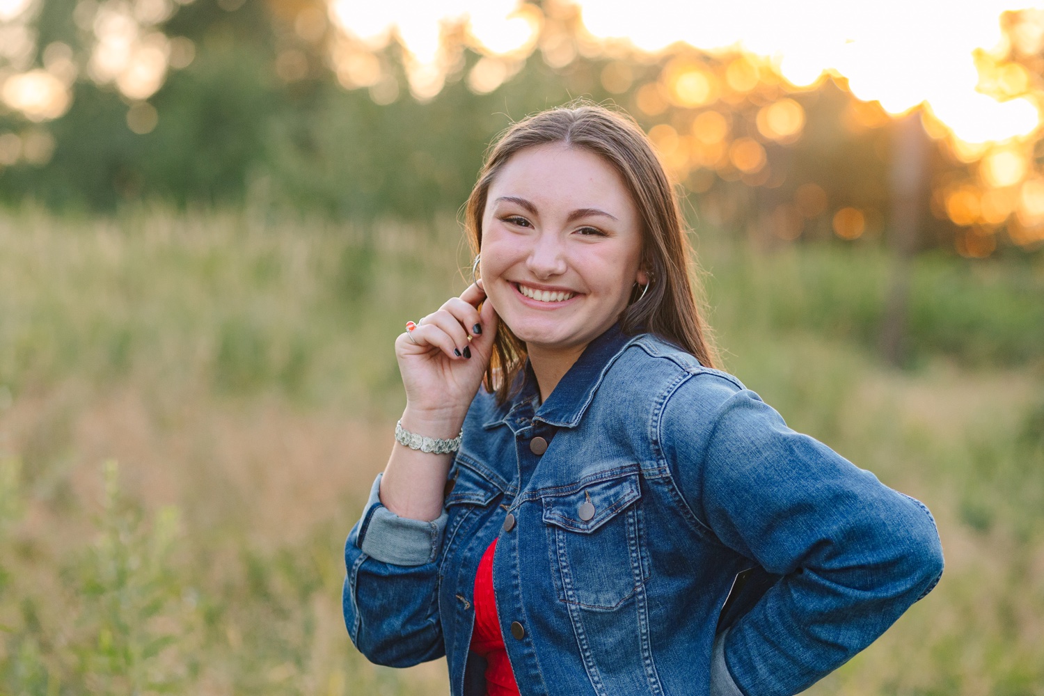 High school senior girl posing in a fall field at OARDC Wooster Ohio during golden hour