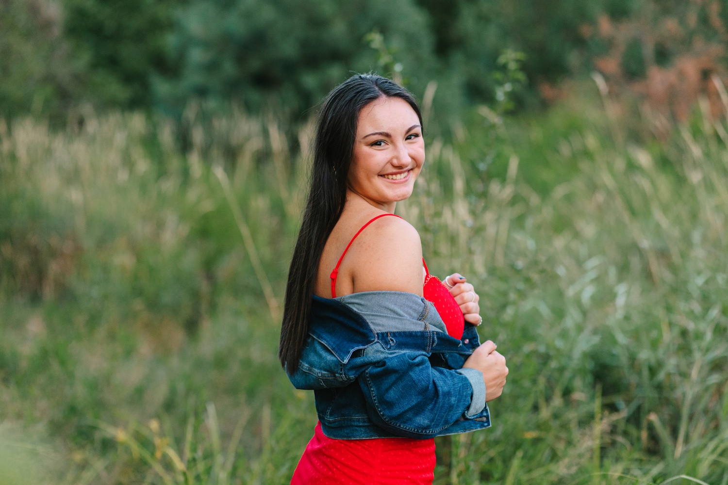 High school senior girl posing in a fall field at OARDC Wooster Ohio during golden hour
