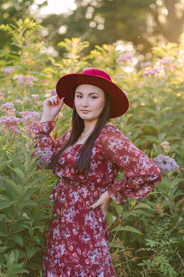 Abbie surrounded by flowers during her senior session