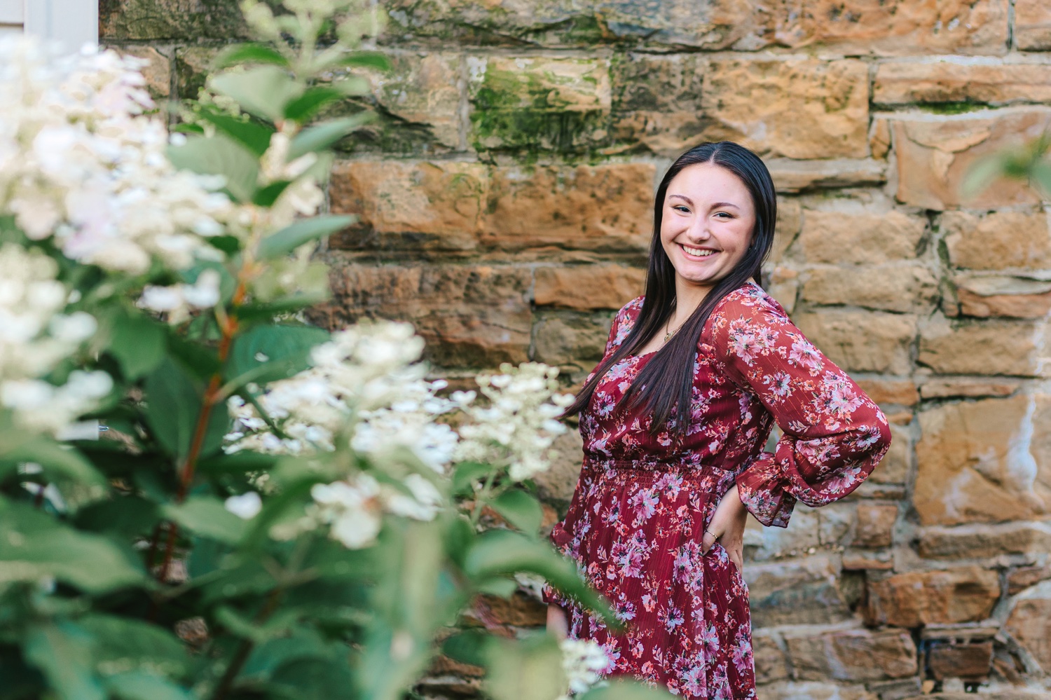 Senior girl posing in a flower bed at OARDC in Orrville Ohio