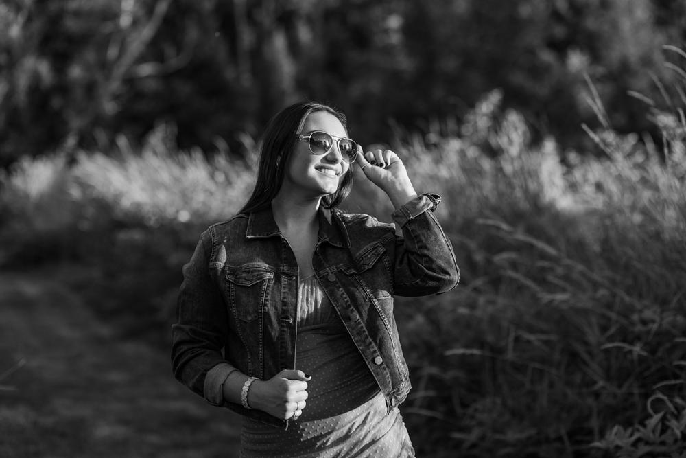High school senior girl posing in a fall field at OARDC Wooster Ohio during golden hour