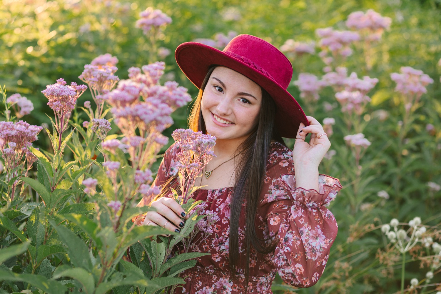 Abbie surrounded by flowers during her senior session