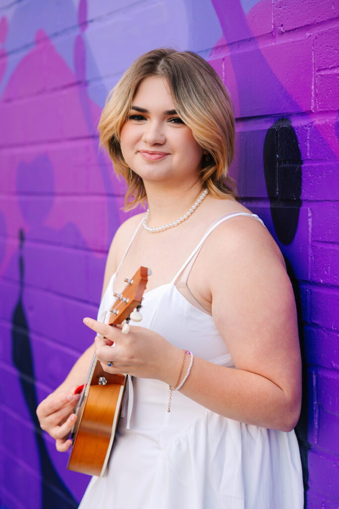Senior photos in Canton Ohio in front of a vibrant, colorful mural