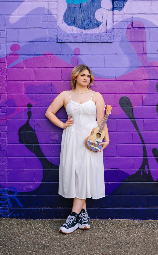 Bright and bold mural as a backdrop for senior girl’s portrait