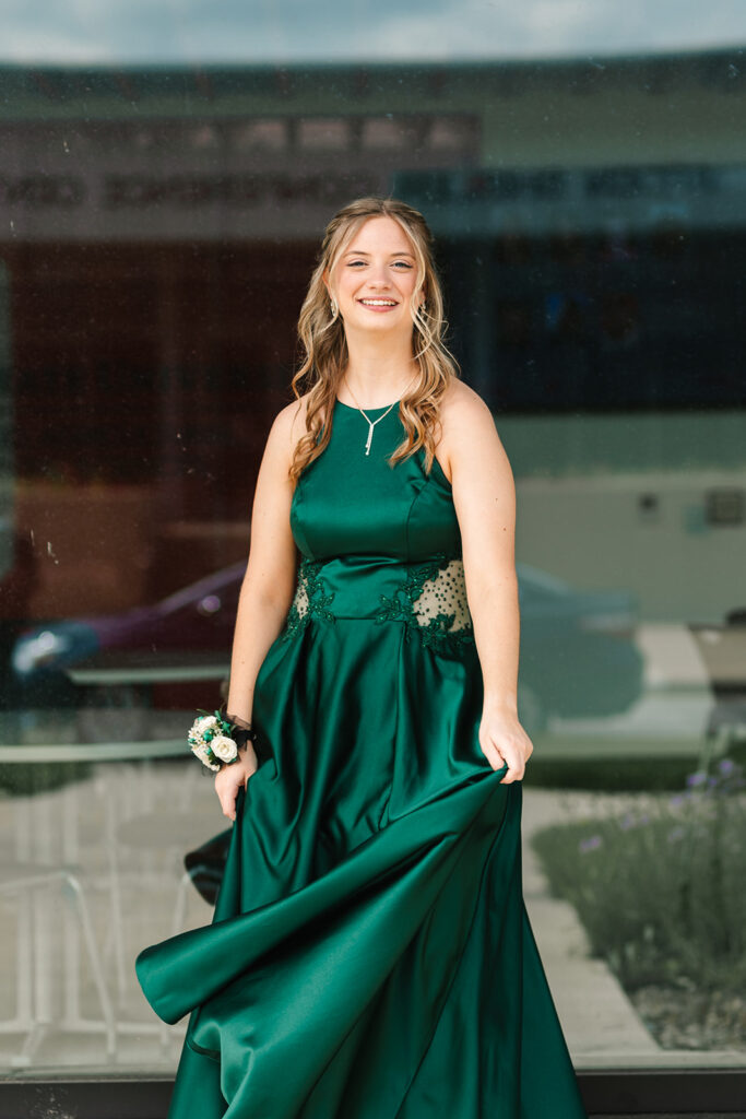 Prom senior girl in Wooster, Ohio, captured by Jamie Lynette Photography. The girl is wearing a green dress and the boy is in a black tux, sharing a joyful moment before prom. These are from their Prom Mini Session.