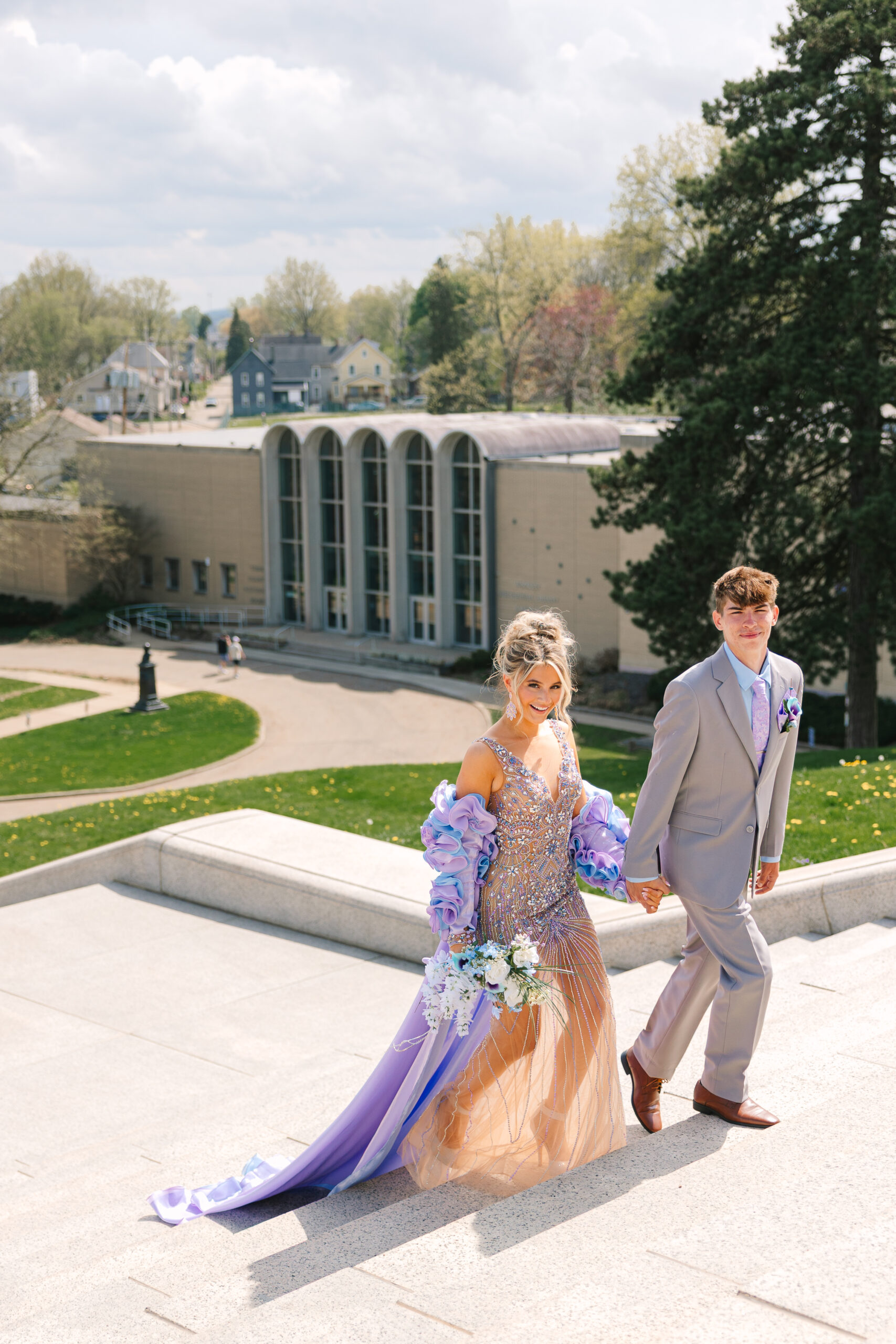 Pastel prom dress from Henri’s Cloud Nine flowing down the McKinley Monument steps in a photo by Canton Ohio photographer