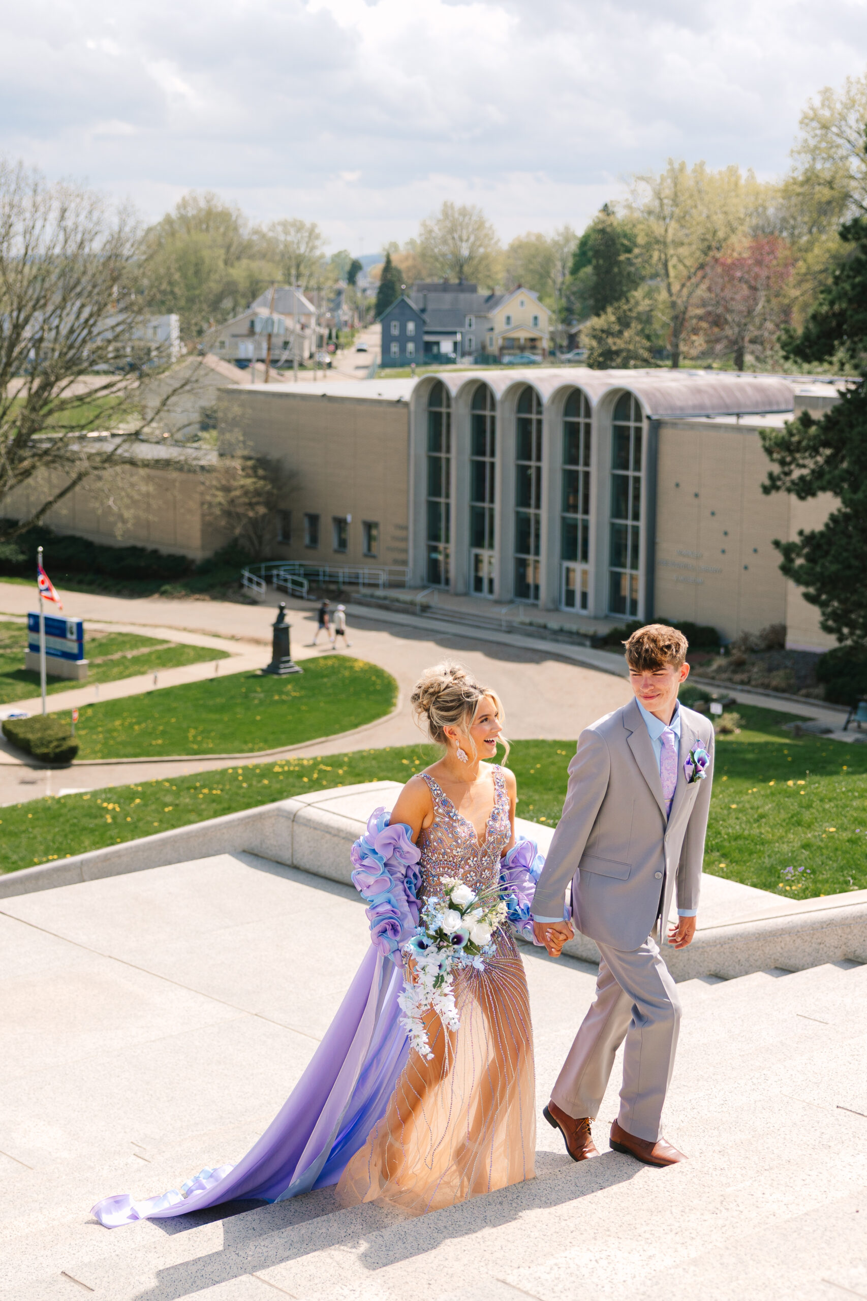 Pastel prom dress from Henri’s Cloud Nine flowing down the McKinley Monument steps in a photo by Canton Ohio photographer