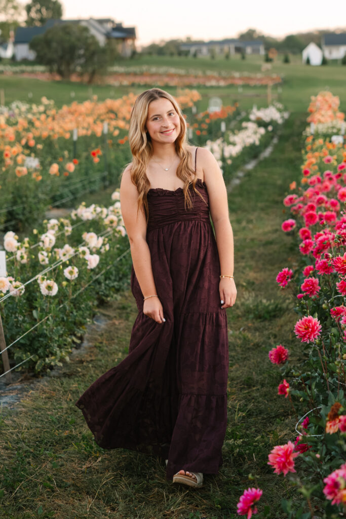 confident senior girl smiling in flower field Northeast Ohio senior photographer