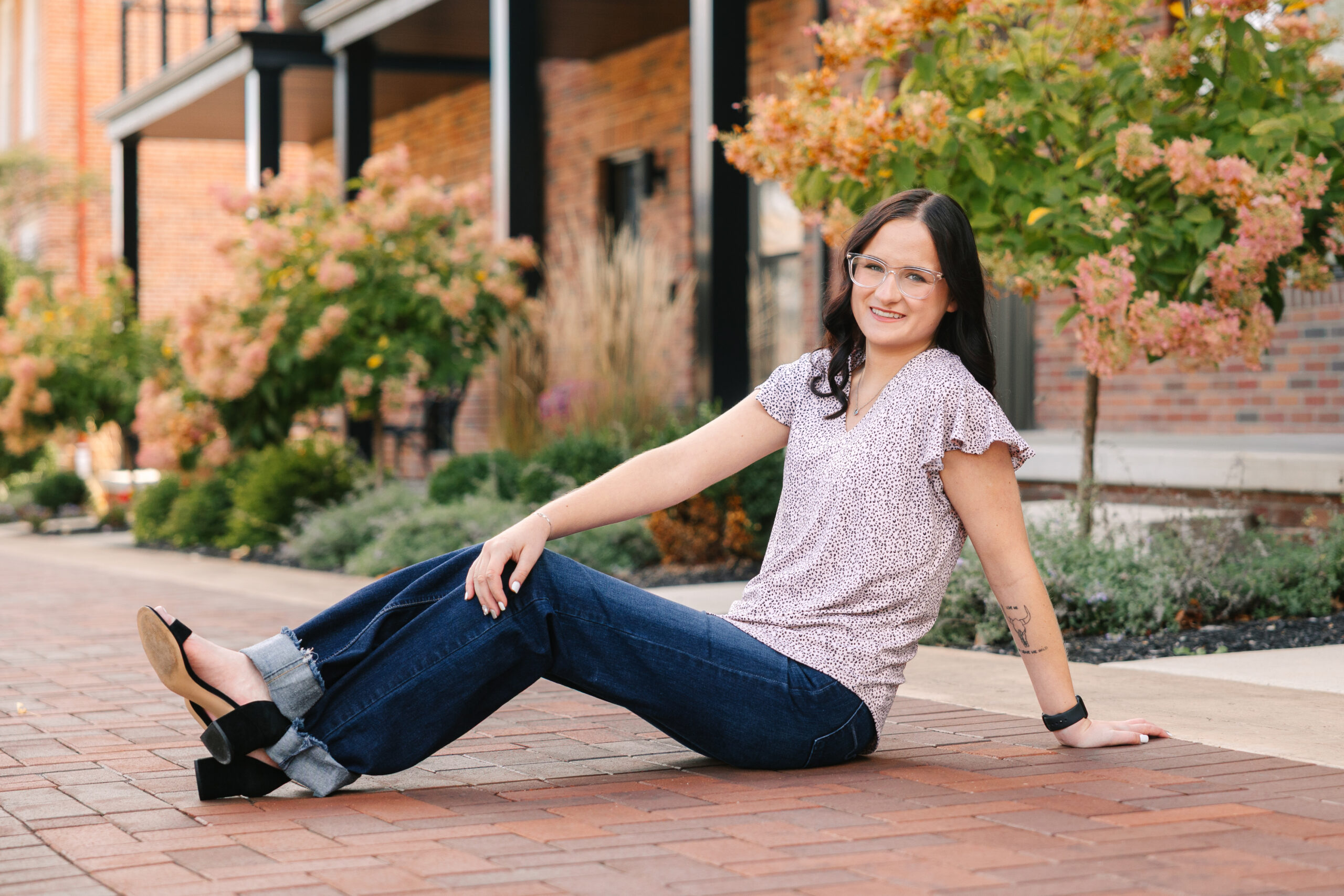 high school senior girl downtown wooster sitting on the sidewalk